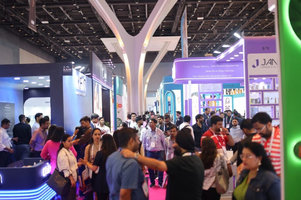 Packed trade exhibition aisle with business buyers and exhibitors networking at a B2B trade show.